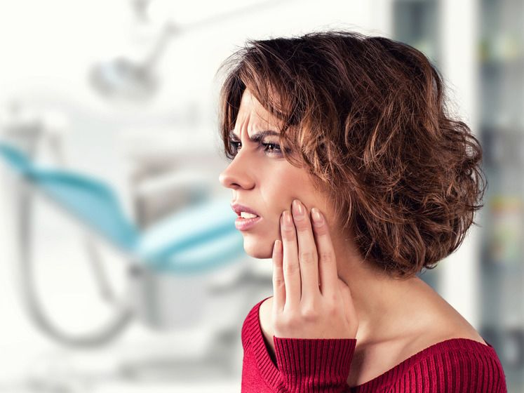 Photo of woman holding jaw