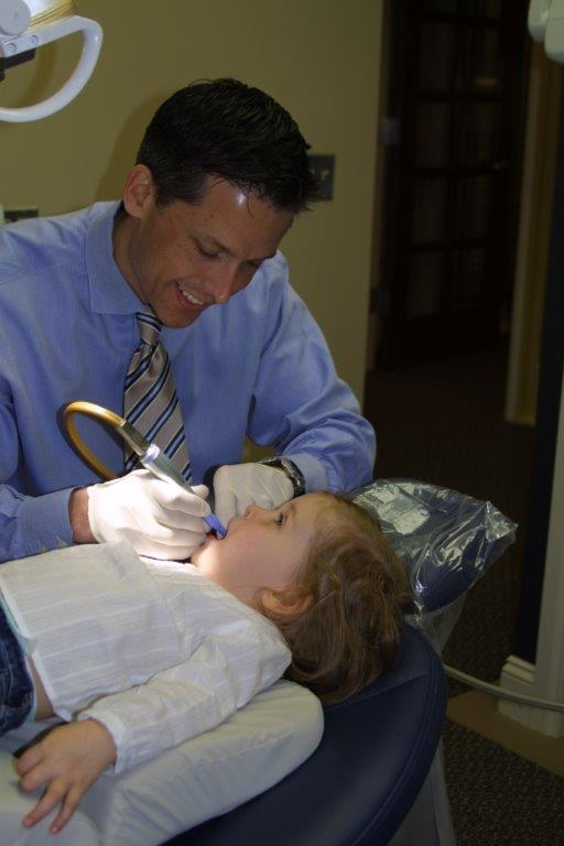 Photo of Dr. Woodward with child patient