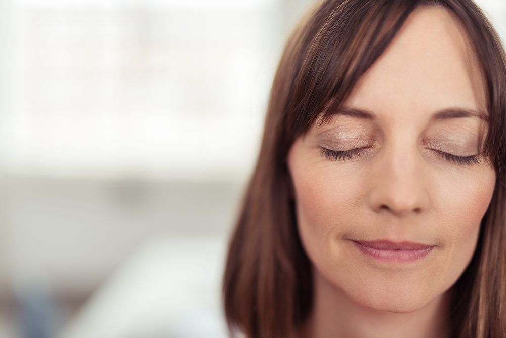 Photo of woman with eyes closed